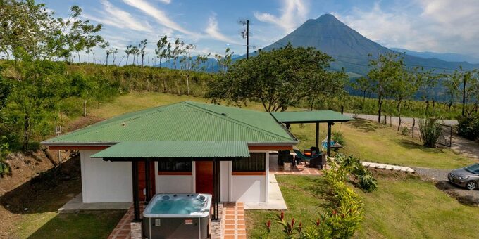 <p>Nestled in the tranquil village of Monterrey, just a short drive from La Fortuna, Arenal Vacation Home is your private oasis for experiencing the wonders of Costa Rica. This comfortable house, perfect for up to five guests, features two bedrooms, a fully-equipped kitchen, a cozy living room, and a terrace with breathtaking Arenal Volcano views. Enjoy the outdoor Jacuzzi, or take advantage of the included day pass to Arenal Springs Resort and Spa. With modern amenities like high-speed internet, a Smart TV, and air conditioning, you'll have everything you need for a relaxing and memorable stay.  Whether you're seeking adventure in Arenal National Park or simply a peaceful retreat surrounded by nature, Arenal Vacation Home is the ideal choice.</p>
<p><strong>Plus, when you book your vacation through us, you'll enjoy a free day pass to access the hot springs and amenities of Arenal Springs Resort including cold water pools, jacuzzi, 3 different restaurants (Italian-international-Japanese), Yoga Classes, Gym, Gift Shop, Changing Rooms and<br>Lockers, enhancing your Costa Rican getaway. </strong></p>